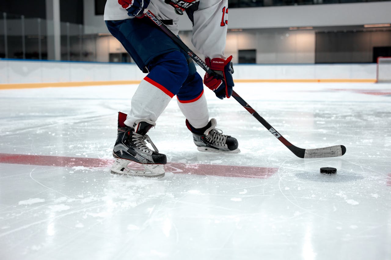 guy skating and playing hockey